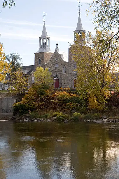 A picture of Chateauguay's St-Jean-Baptiste church across the ChÃ¢teauguay river.
