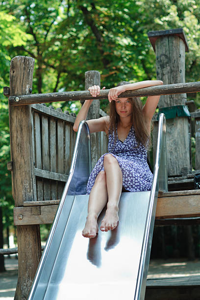 istock woman on a child slide 152166040