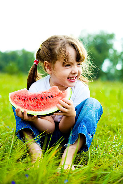 girl eating water-melon stock photo