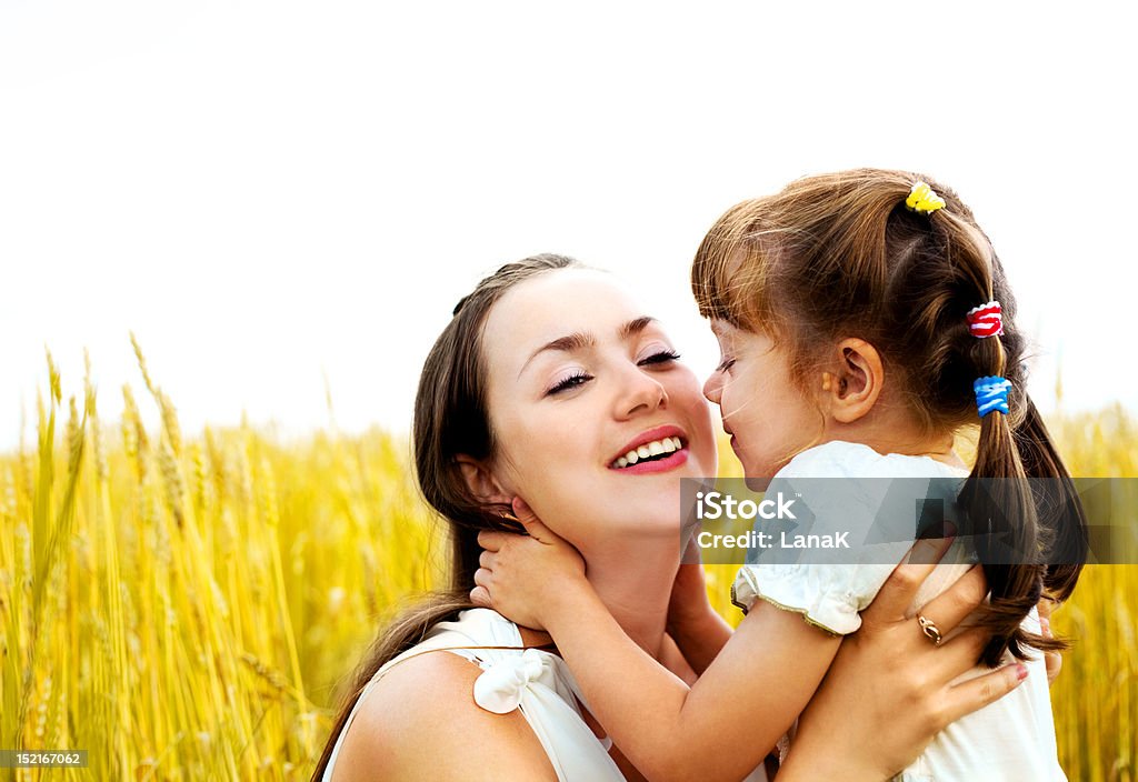 mother and daughter young mother and her daughter at the wheat field on a sunny day Adult Stock Photo