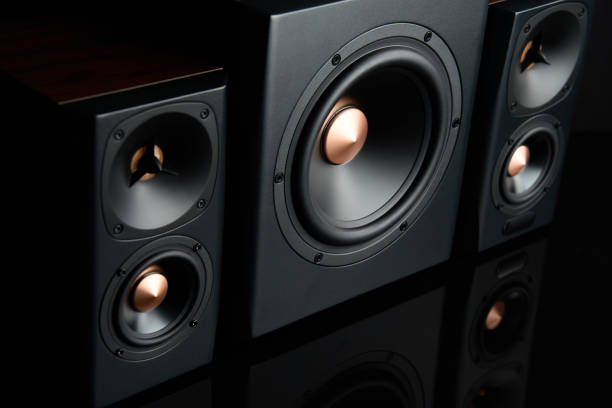 istock Sound audio system with two satellites and subwoofer on dark background. 1521673576