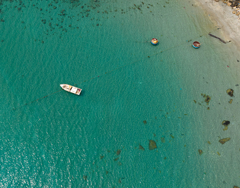 Abstract aerial photo of a lonely boat in the blue sea in Con Dao, Con Son island, Ba Ria Vung Tau province