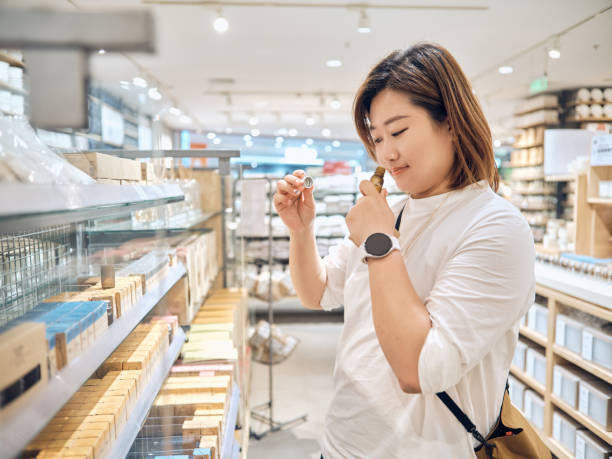 chinka kupująca perfumy w centrum handlowym - asian ethnicity women shopping mall perfume zdjęcia i obrazy z banku zdjęć