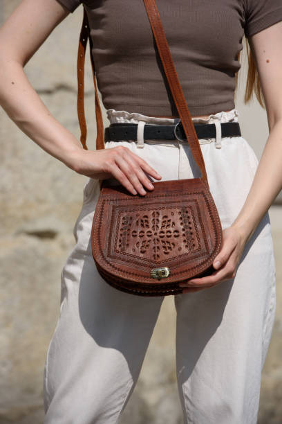 istock small light brown women's leather bag with a carved pattern. selective focus 1521691928
