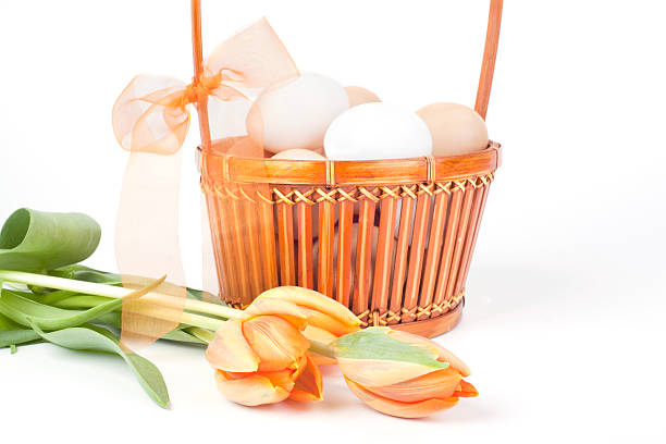 Eggs in a basket and tulips stock photo