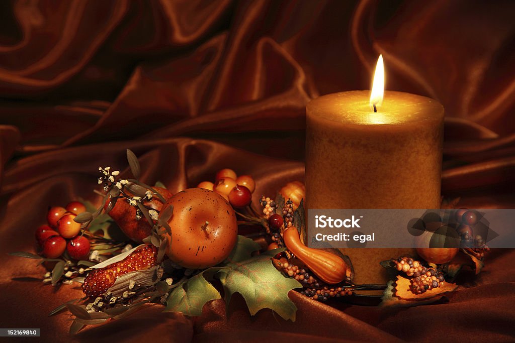 Autumn candle Autumn candle on a brown backdrop Autumn Stock Photo