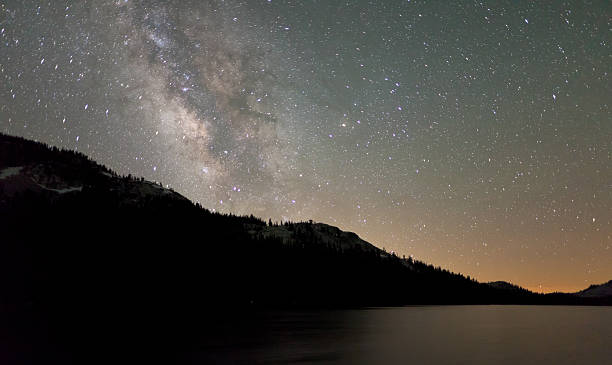 Milky Way over the Calm Waters of Tenaya Lake stock photo