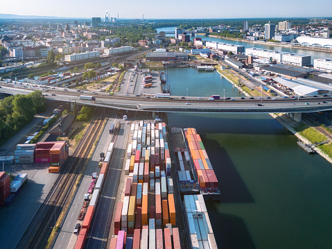 arial view on cargo container harbor and bridge behind in Mannheim at sunny morning