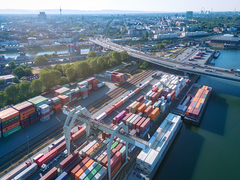 arial view on cargo container harbor and bridge behind in Mannheim at sunny morning, Mannheim has the second biggest inland harbor of europe