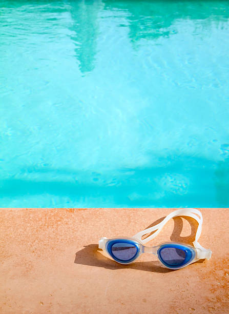 istock Swimming goggles at the edge of a pool 152171080