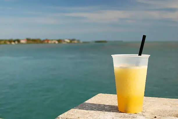 A refreshing yellow drink overlooking the sea.