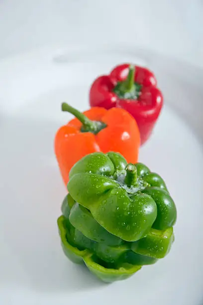 3 Bell peppers on a white serving plate