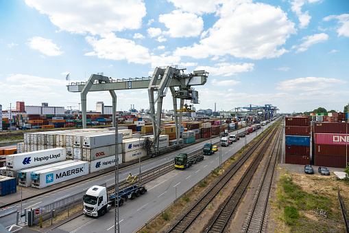 view on cargo container terminal at riverside in Mannheim at sunny morning, Mannheim has the second biggest inland harbor of europe