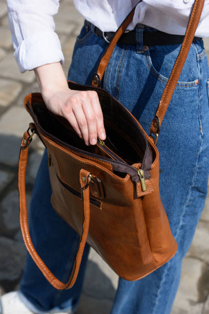 istock woman opening small light brown women's leather bag 1521727484