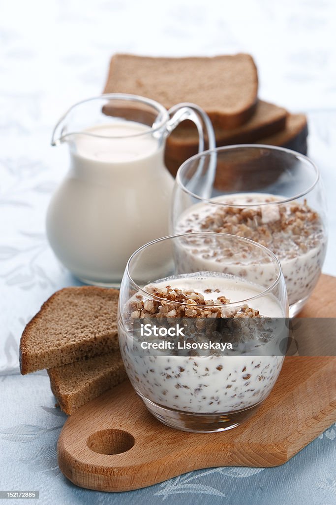 Boiled buckwheat with milk Boiled buckwheat with milk on served table on white background Boiled Stock Photo