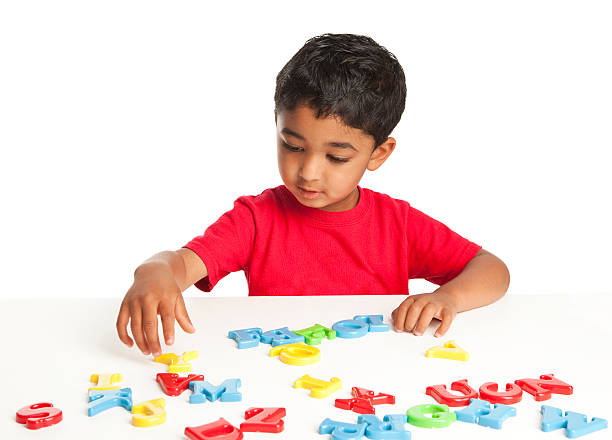 Toddler Playing with Alphabets stock photo