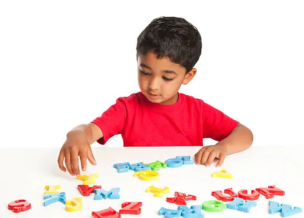 Photo of Toddler Playing with Alphabets