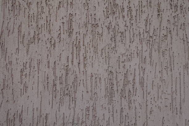 Surface of dusty brown wall with stucco worm finish