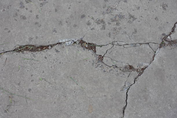 istock View of light grey concrete slab with numerous cracks from above 1521740774