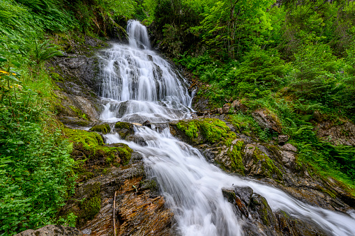 Beautiful waterfall in the mountains of the Alps. Silbertal, Montafon, Vorarlberg