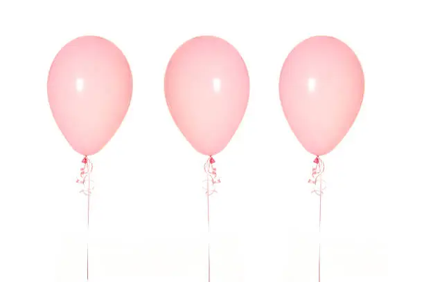 Three Pink Balloons in a Row on White Background