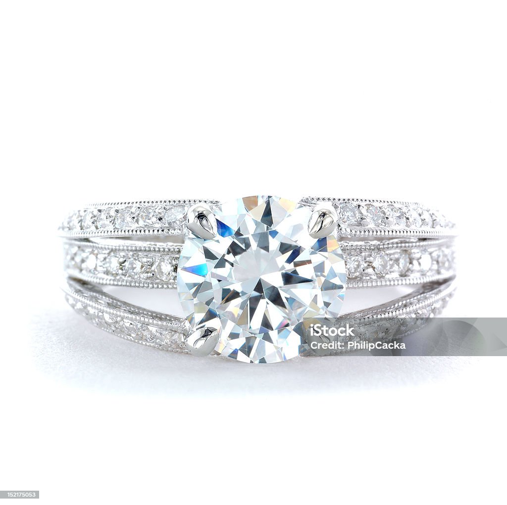 Woman's Diamond and Platinum Wedding Ring Woman's diamond and platinum wedding ring with a round brilliant-cut center diamond.  Isolated on a white background. Diamond Ring Stock Photo