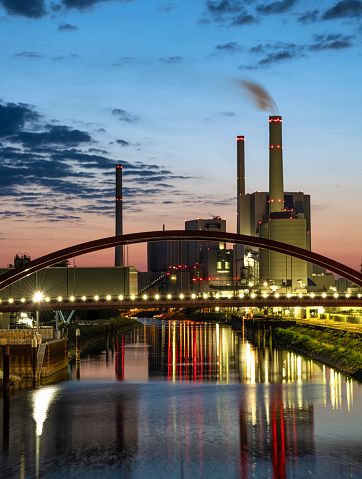 colorful illuminated silhouette of power station in Mannheim at blue hour