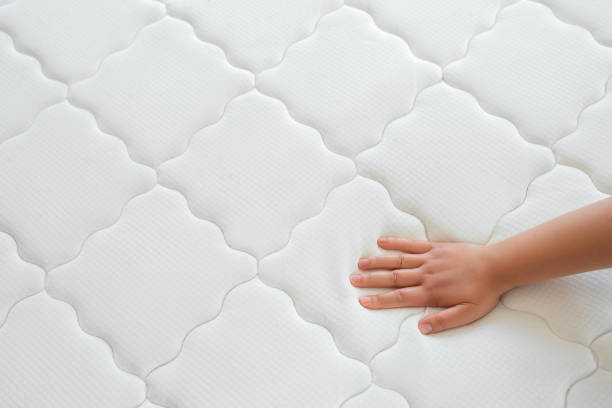 istock Woman hand testing orthopedic memory foam core mattress 1521773209