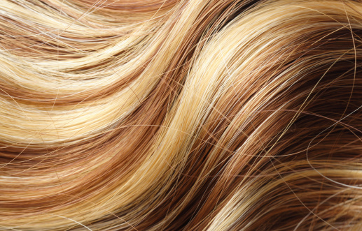 A woman's long blonde wavy hair