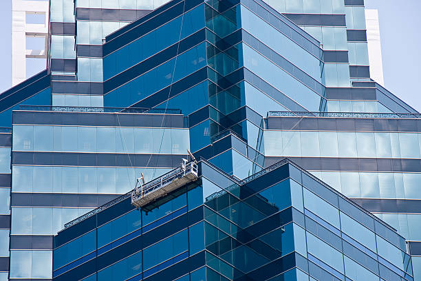 istock Blue Angled Glass Walls with Window Washers Scaffold 152178245