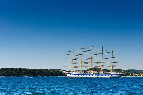 Stock photo of classic sailboat anchored in Adriatic harbor. Turistic excursion ship, popular tourist attraction.