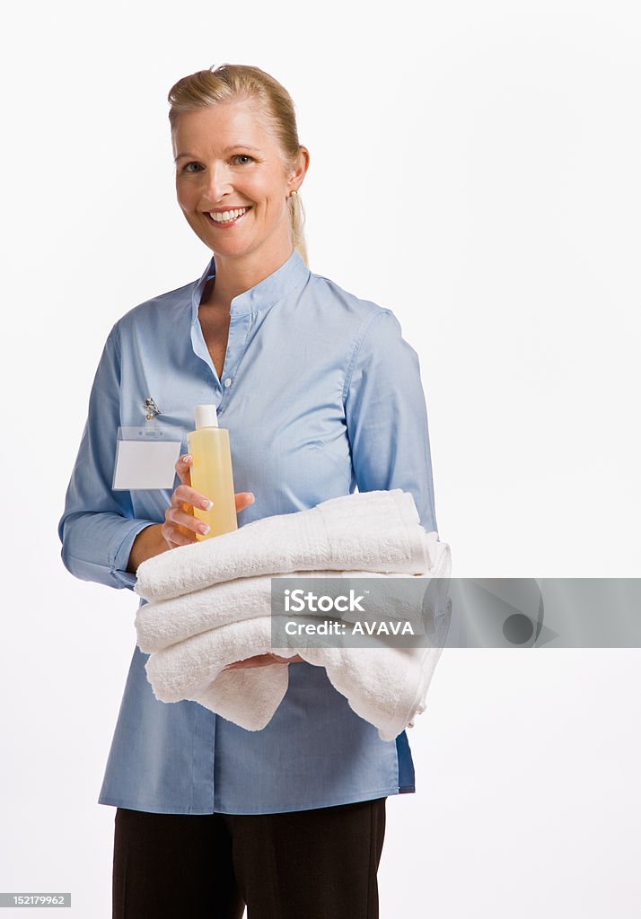 Massage therapist holding oil and towels Adult Stock Photo