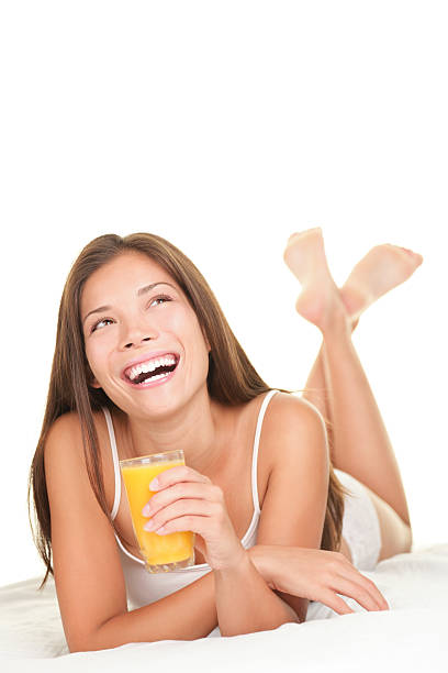 istock Cheerful morning woman drinking orange juice 152180034