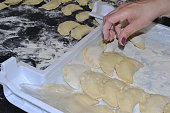 A woman makes molded dumplings