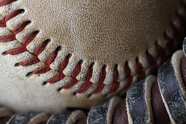 close up of ball nestled in glove stock photo