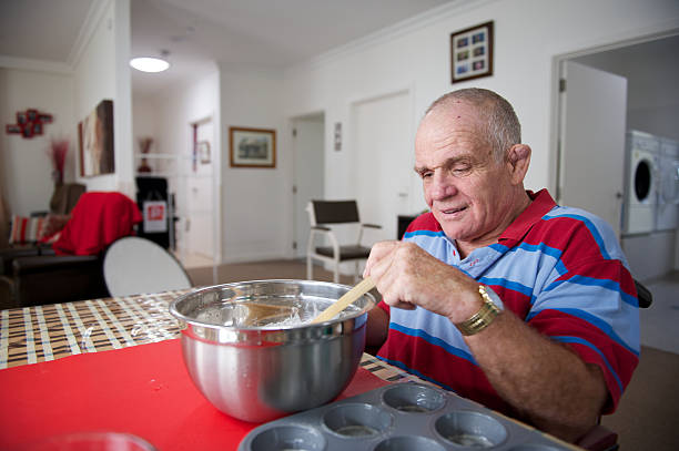 istock Man with an Intellectual Disability preparing a cake mix 152183075