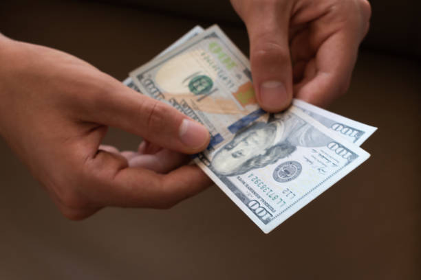 istock US dollars money, man hands 1521844808