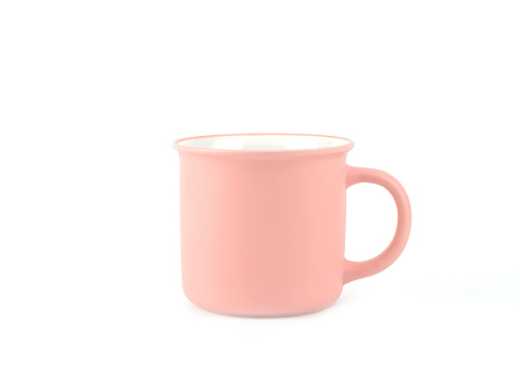 Empty pink color mug for coffee or tea isolated on white background. Use for home or restaurant, food design. Concept kitchen utensils and tableware.