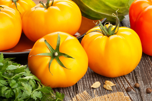 yellow tomato on wood background