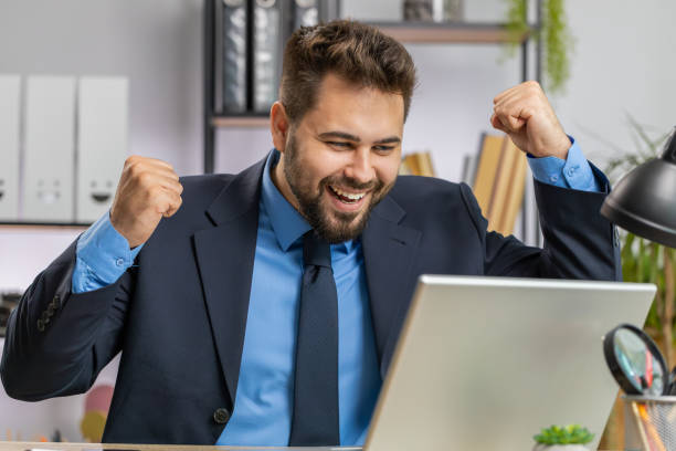 istock Business man winner working browsing typing on laptop at office celebrate big lottery win good news 1521870994