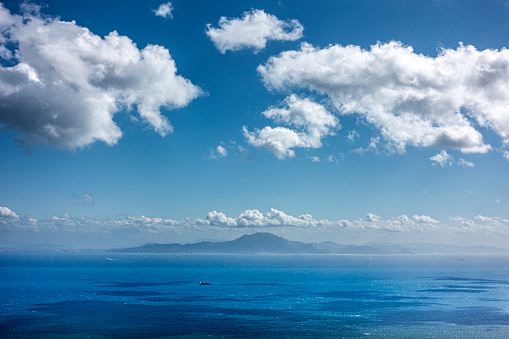 The view of the Strait of Gibraltar sea with the clouds in the sky