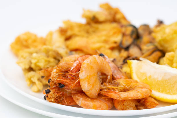 Grilled shrimp with lemon and other seafood on the plate