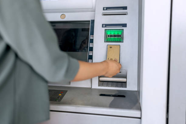 istock Unrecognisable woman using credit cart at ATM machine 1521885951