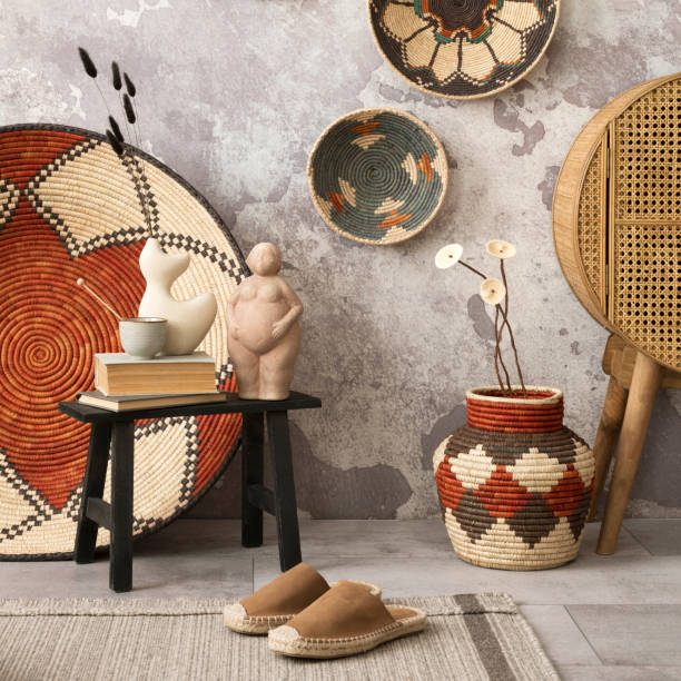 istock Ethnic composition of living room interior with colorful baskets, rattan sideboard, black stool, beige vase with dried flowers and elegant personal accessories. Home decor. Template. 1521891713
