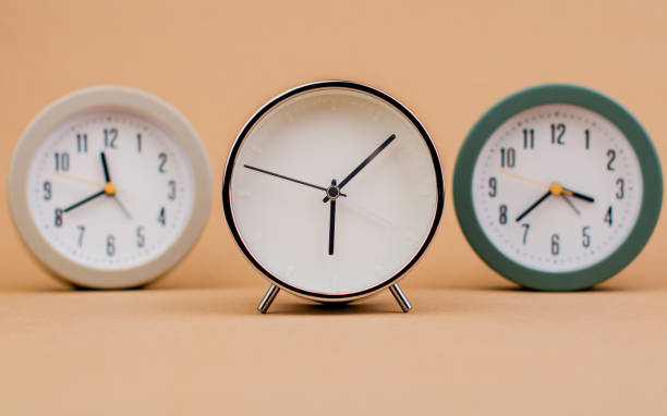 istock Alarm clock. Beautiful modern clock lies on paper background. time clock time standstill time off work working with time time concept 1521897618