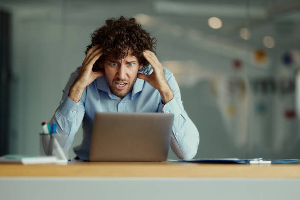 istock Frustrated businessman working on laptop in the office. 1521898182