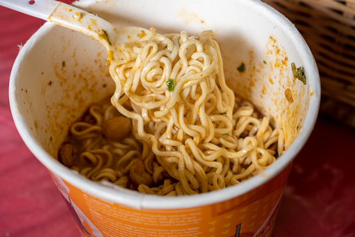 Spicy cup instant noodles with white Plastic cutlery