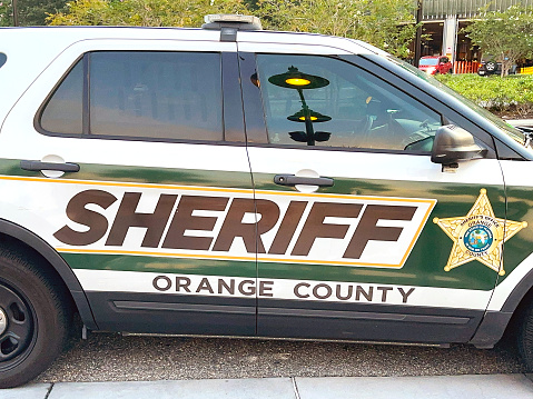 Orlando, Florida, USA - 20 June 2023: Side view of a patrol car of the Orange County Sheriff department parked near the city centre