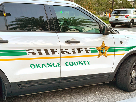 Orlando, Florida, USA - 20 June 2023: Side view of a patrol car of the Orange County Sheriff department parked near the city centre