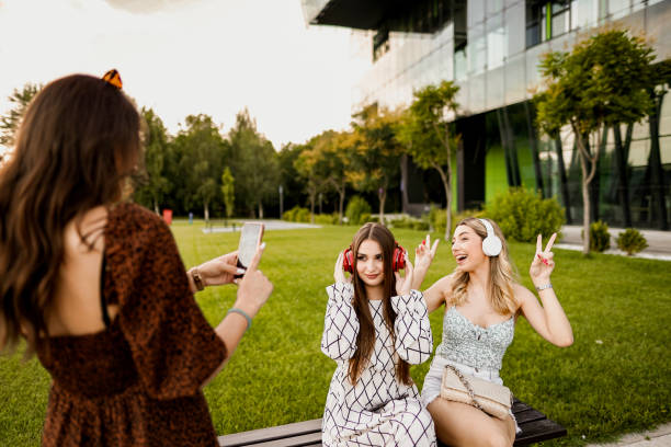istock Three smiling bestfriends taking pictures in the park 1521991869